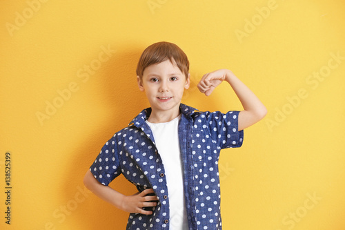 Cute little boy on color ba...