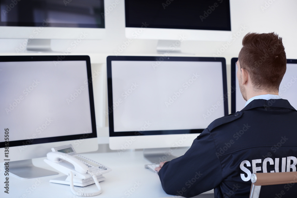 Handsome security guard in surveillance room Handsome security guard in surveillance room