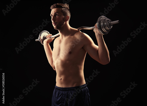 Sporty man doing exercises ...