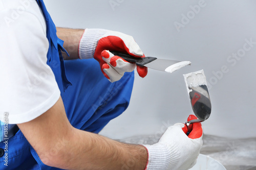 Professional worker making repair in room
