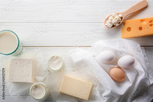 Assortment of natural dairy products on white wooden table