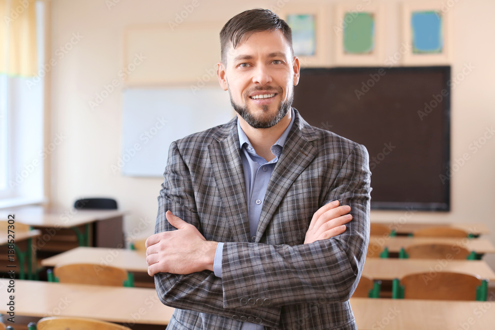 Portrait of happy teacher in classroom