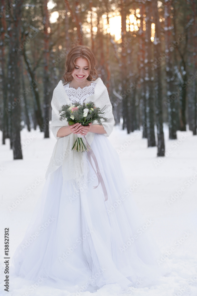 Fototapeta premium Beautiful bride with bouquet outdoors on winter day