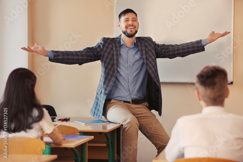 Pupils listening teacher in...