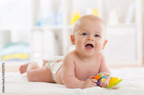 Laying small baby with a to...