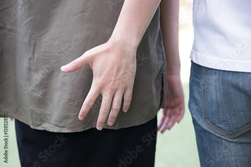 man hand touching woman bottom photo