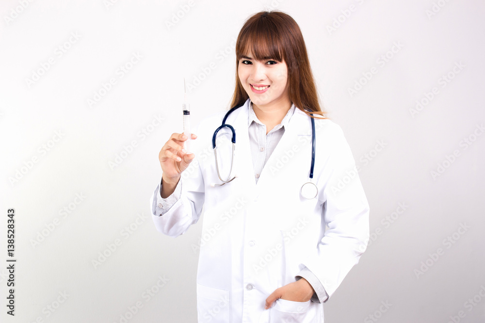 Young Asian female doctor with mask hold syringe isolated on white background. Young Asian female doctor with mask hold syringe isolated on white background.