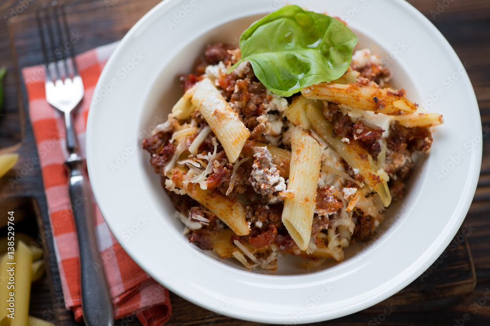 Close-up of ziti casserole served in a white glass plate