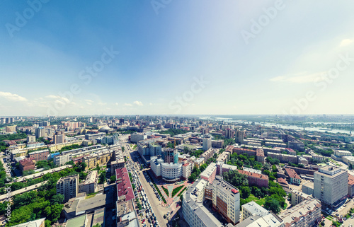 Aerial city view with crossroads and roads, houses, buildings, parks and parking lots, bridges. Urban landscape. Copter shot. Panoramic image. © mr.markin