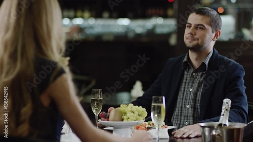 curling girl talking to partner at front in restaurant photo