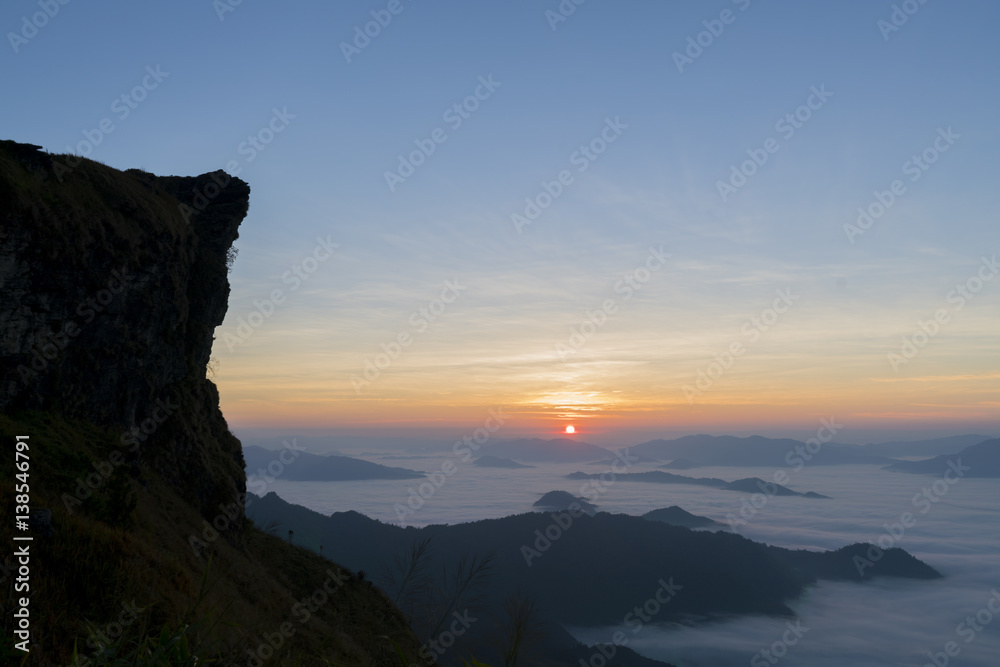 Sunrise on mountain with fog in the morning.
