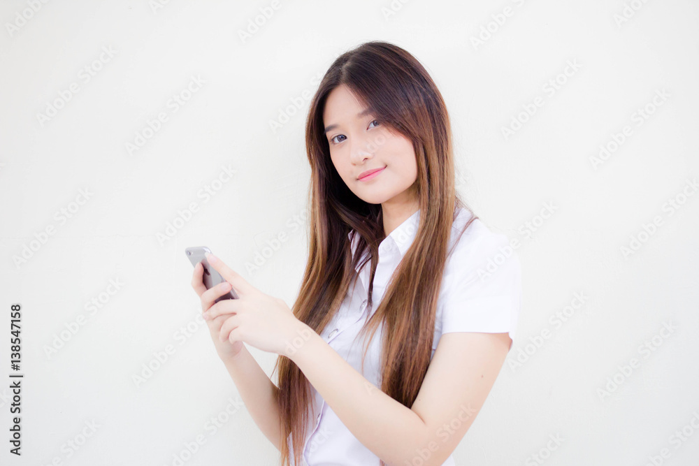 Portrait of thai adult student university uniform beautiful girl using her smart phone Portrait of thai adult student university uniform beautiful girl using her smart phone