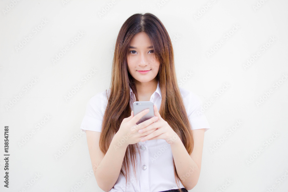 Portrait of thai adult student university uniform beautiful girl using her smart phone Portrait of thai adult student university uniform beautiful girl using her smart phone