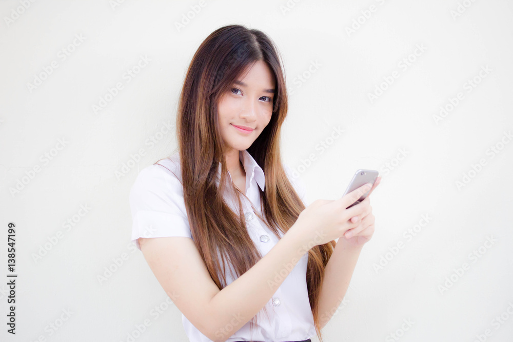 Portrait of thai adult student university uniform beautiful girl using her smart phone Portrait of thai adult student university uniform beautiful girl using her smart phone