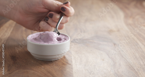 Wallpaper Mural teen girl eating blueberry yogurt with spoon, 4k photo Torontodigital.ca