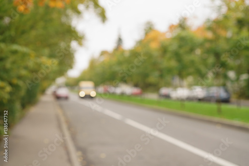 blurred background of autumn town street, real lens bokeh