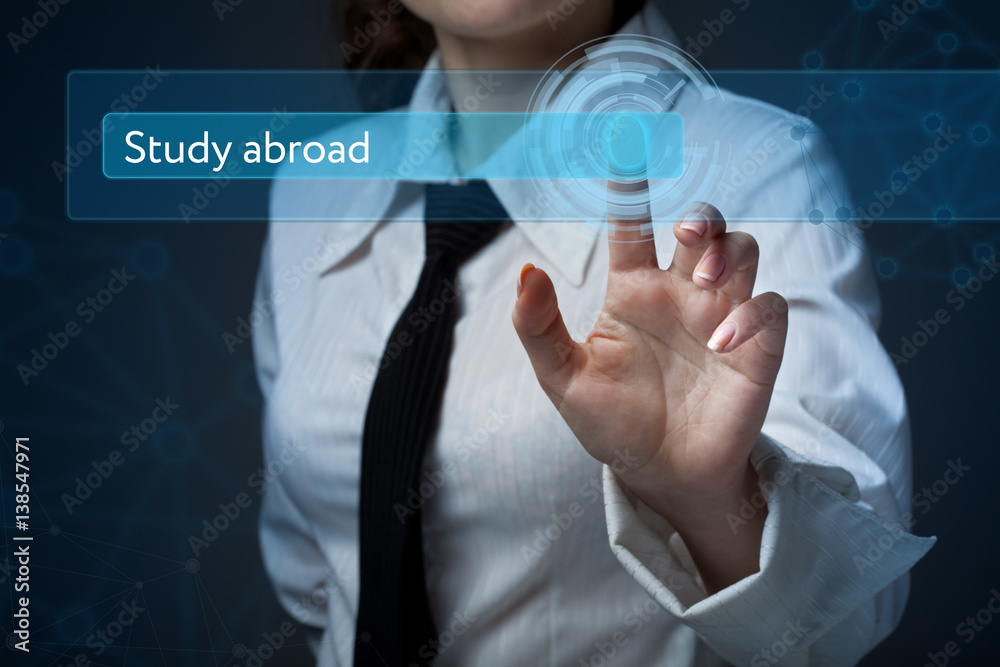 Business, technology, internet and networking concept. Business woman presses a button on the virtual screen: Study abroad Business, technology, internet and networking concept. Business woman presses a button on the virtual screen: Study abroad