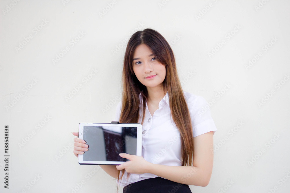 Portrait of thai adult student university uniform beautiful girl using her tablet. Portrait of thai adult student university uniform beautiful girl using her tablet.