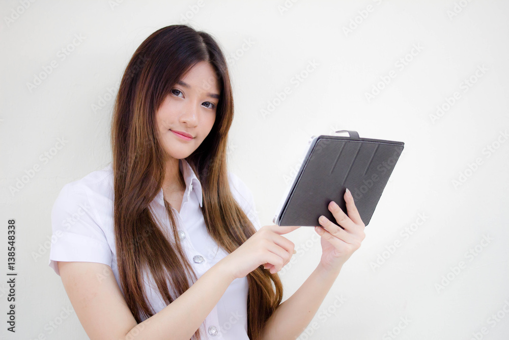 Portrait of thai adult student university uniform beautiful girl using her tablet. Portrait of thai adult student university uniform beautiful girl using her tablet.