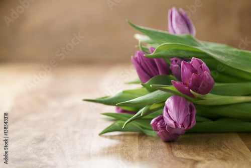 bouquet of purple tulips on wood table with copy space  shallow focus
