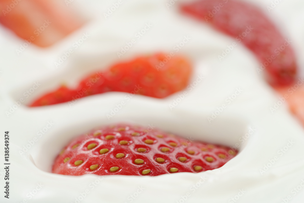 macro photo of organic yogurt with fresh sliced strawberries, food background