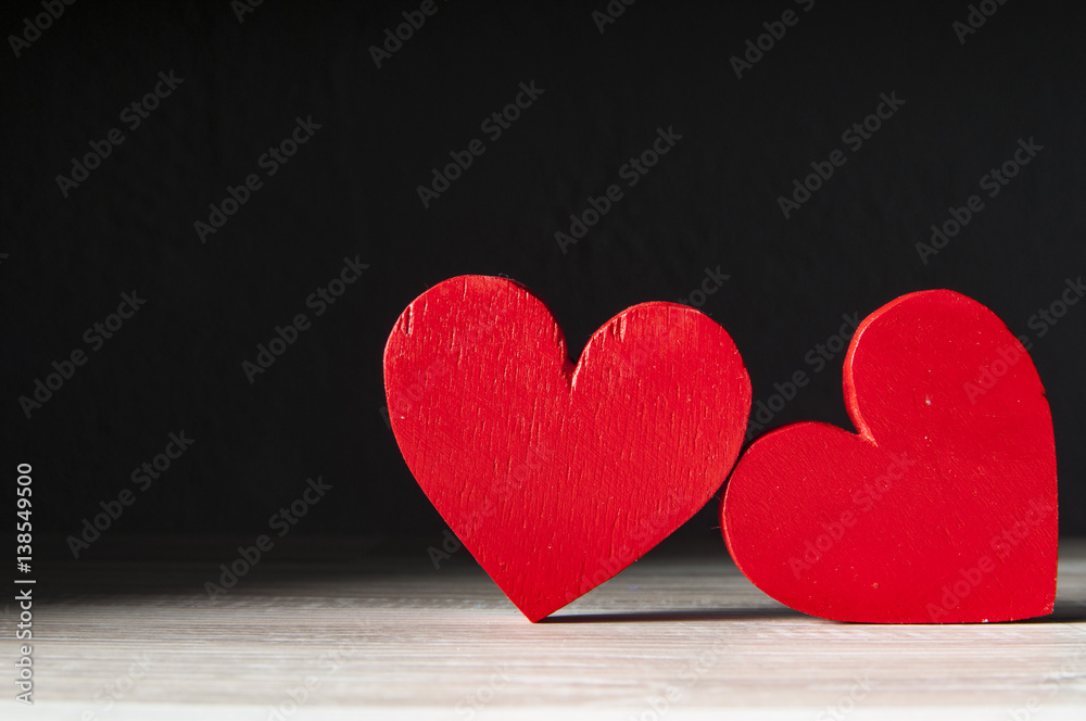 Obraz premium two hearts on dark wooden background
