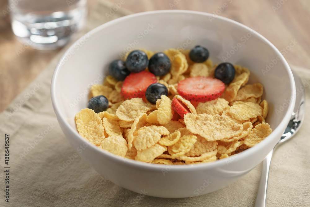 berries falling into corn flakes for breakfast in bowl on table, breakfast preparation berries falling into corn flakes for breakfast in bowl on table, breakfast preparation