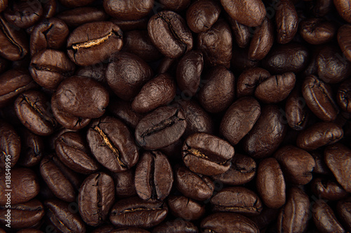 Roasted coffee beans closeup top view as background.