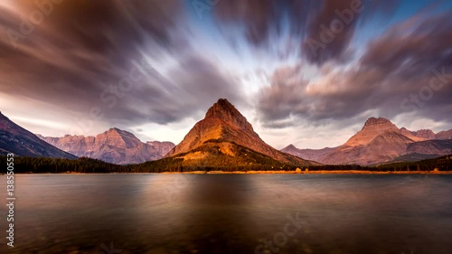 Sunrise in Glacier National Park, Montana with dramatic sky in motion photo