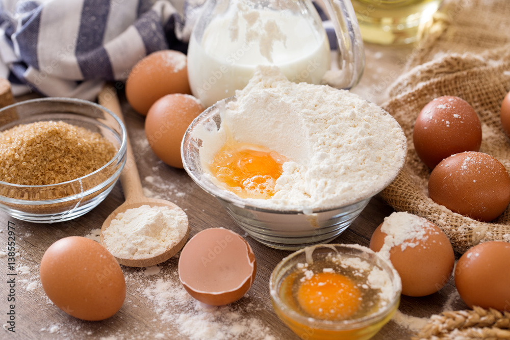 Breaking eggs into flour to making cakes. Breaking eggs into flour to making cakes.