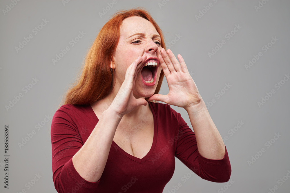 Nervous young woman with red hair shouting Nervous young woman with red hair shouting