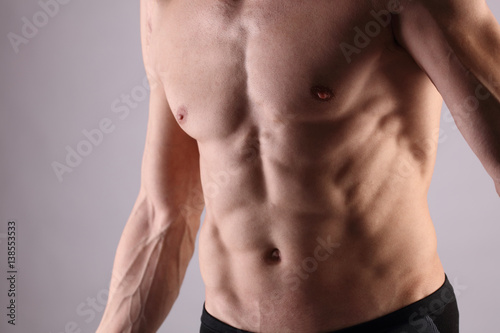 Close up of muscular male torso  chest and armpit hair removal. Male Waxing