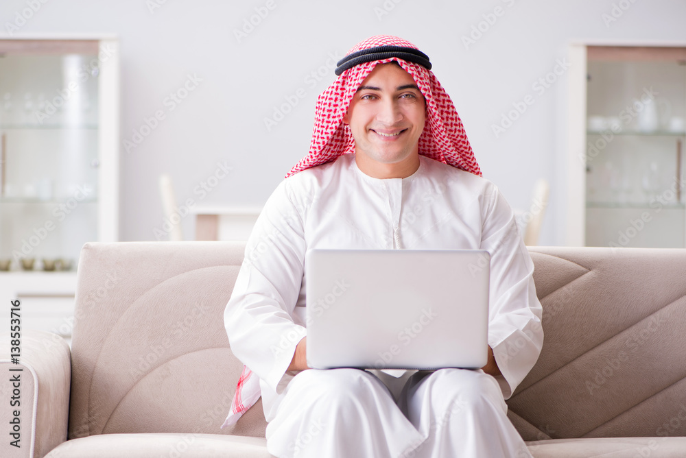 Young arab businessman working with laptop on sofa Young arab businessman working with laptop on sofa