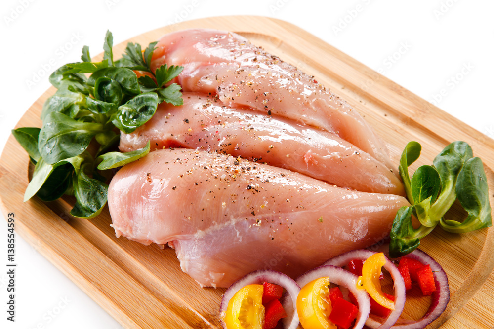 Raw chicken breasts on cutting board Raw chicken breasts on cutting board