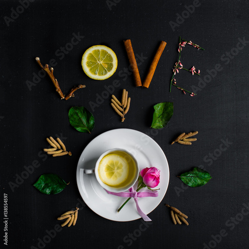 Tea with lemon on a black background