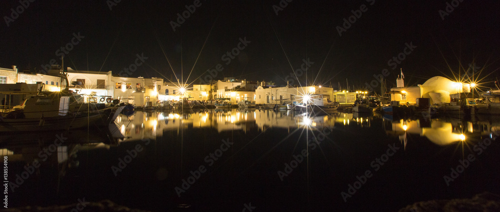 White walls of greek town reflecting in water