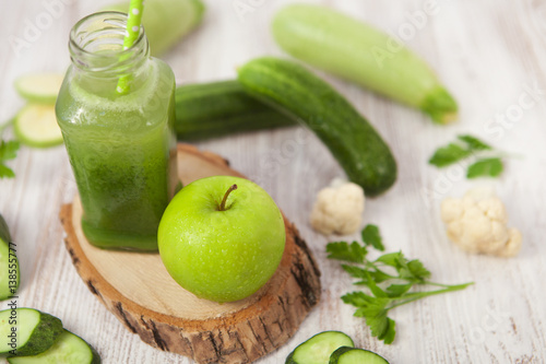 Green Healthy smoothie and apple on white background