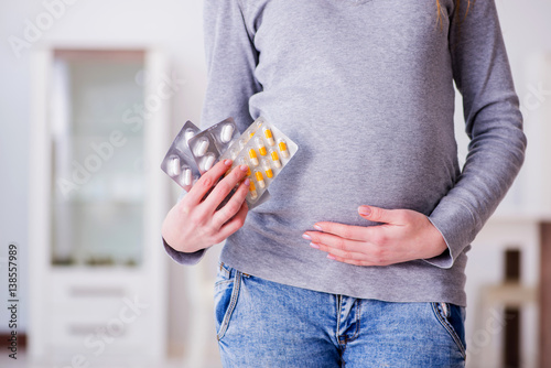 Pregnant woman taking pills during pregnancy
