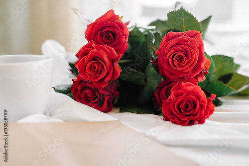 cup of coffee and a bouquet of red roses  envelope