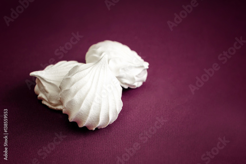 White marshmallow. Marshmallows on a cherry background. The sweetness of the tea. Airy meringue. Delicious dessert.