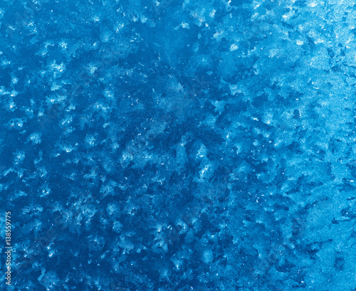 Beautiful abstract blue background is frosty pattern highlighted in blue.