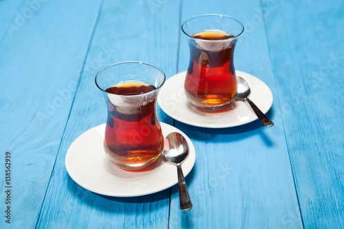 Cups of tea on a blue wooden background