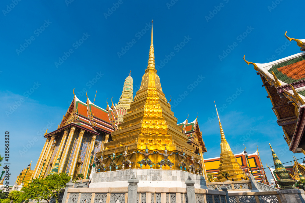 Golden pagoda with giant statue at Royal grand palace temple