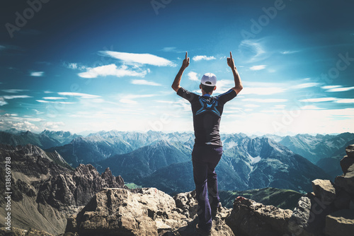 Mountaineer celebrating reaching the summit