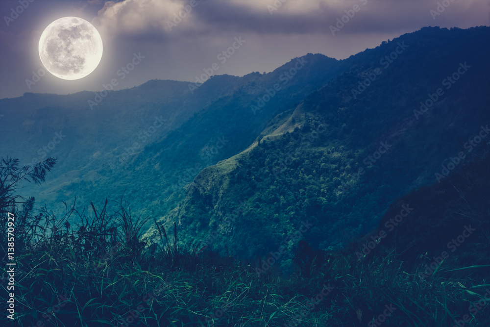 Mountain peaks with sky and beautiful full moon.