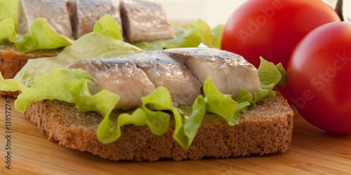 sandwich with herring and tomatoes photo