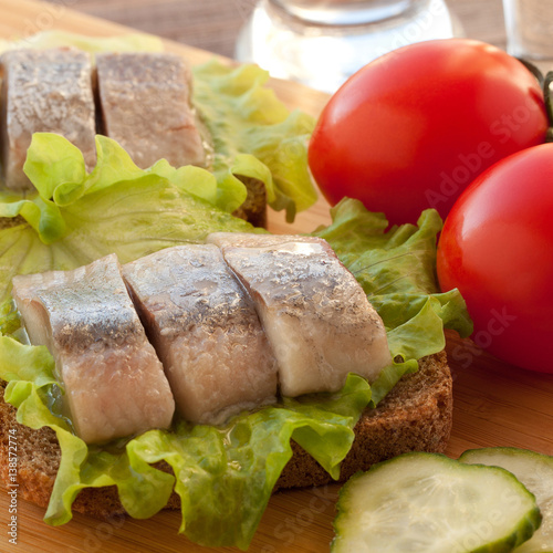 sandwich with herring, tomatoes and cucumber photo