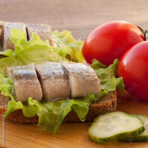 sandwich with herring, tomatoes and cucumber photo