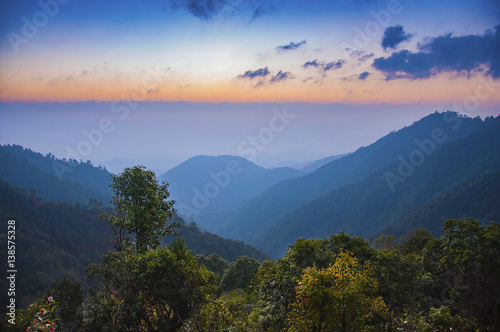 View of mountains, autumn landscape with foggy hills at sunrise