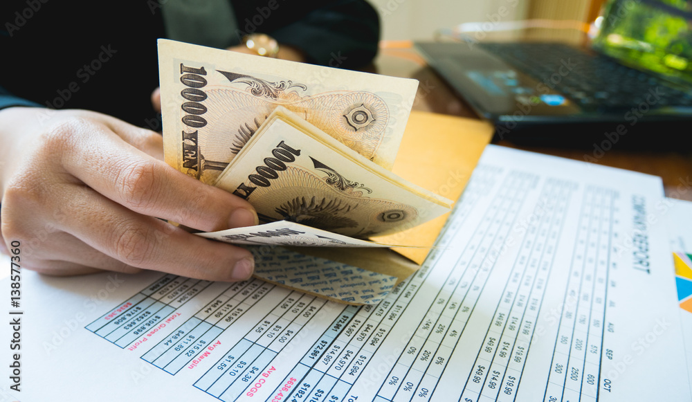 Obraz premium Woman is counting money with statement paper financial concept.
